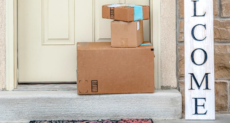 Packages on the doorstep of a home with a welcome sign in Sioux City